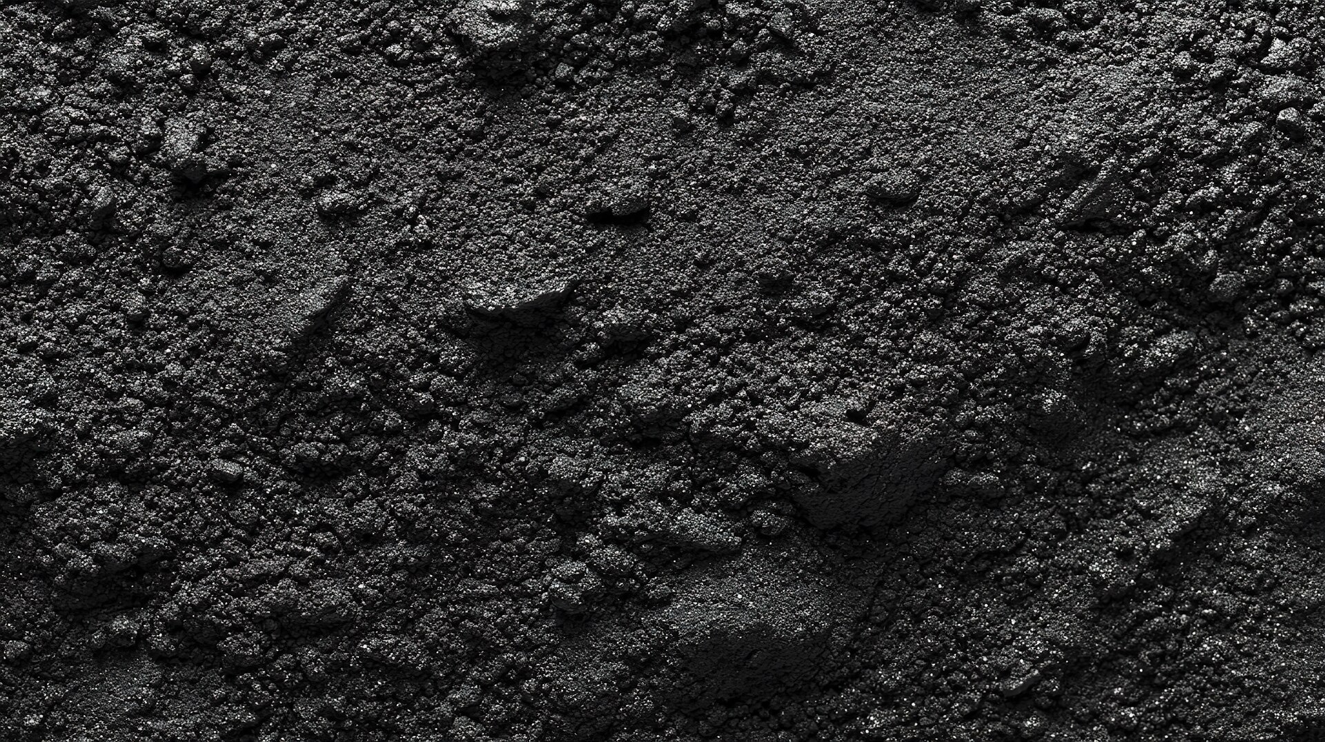 Close-up of black carbon powder with granular texture.